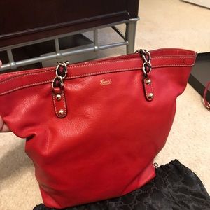 Red Gucci tote with chain straps.
